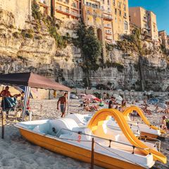 A small pedal boat on a beach in Tropea, Italy